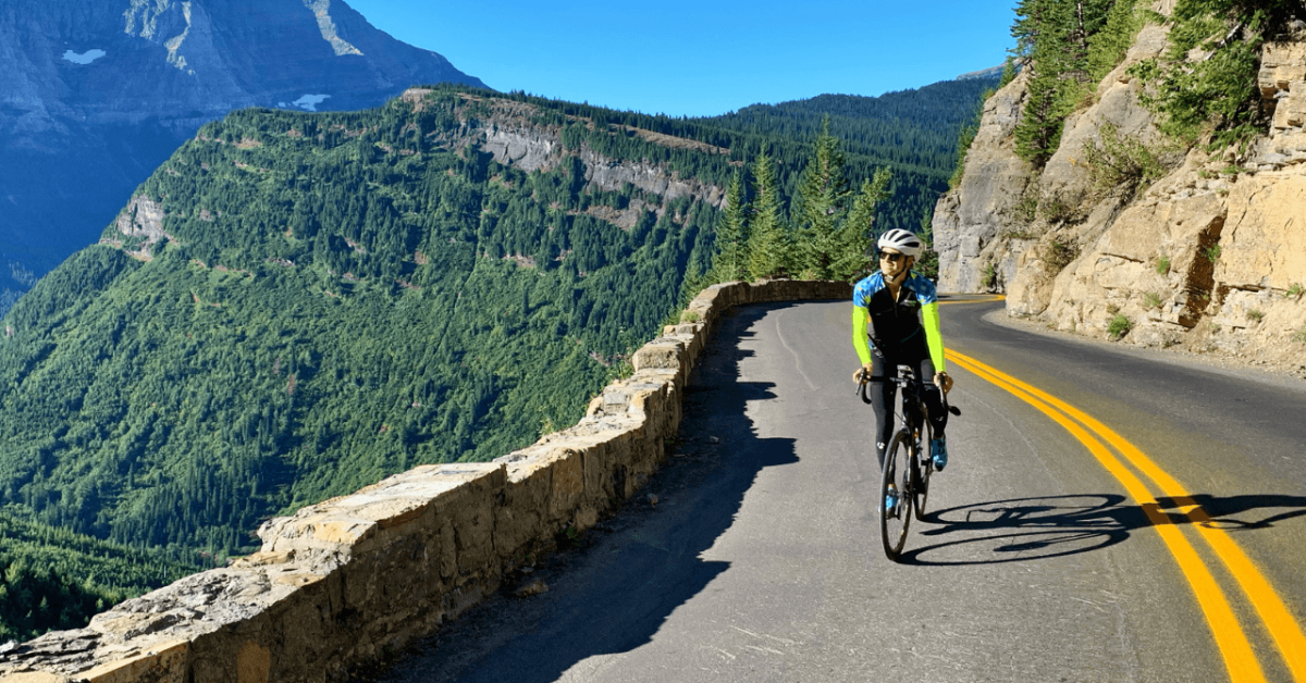 Man on bike on going to the sun road in glacier national park